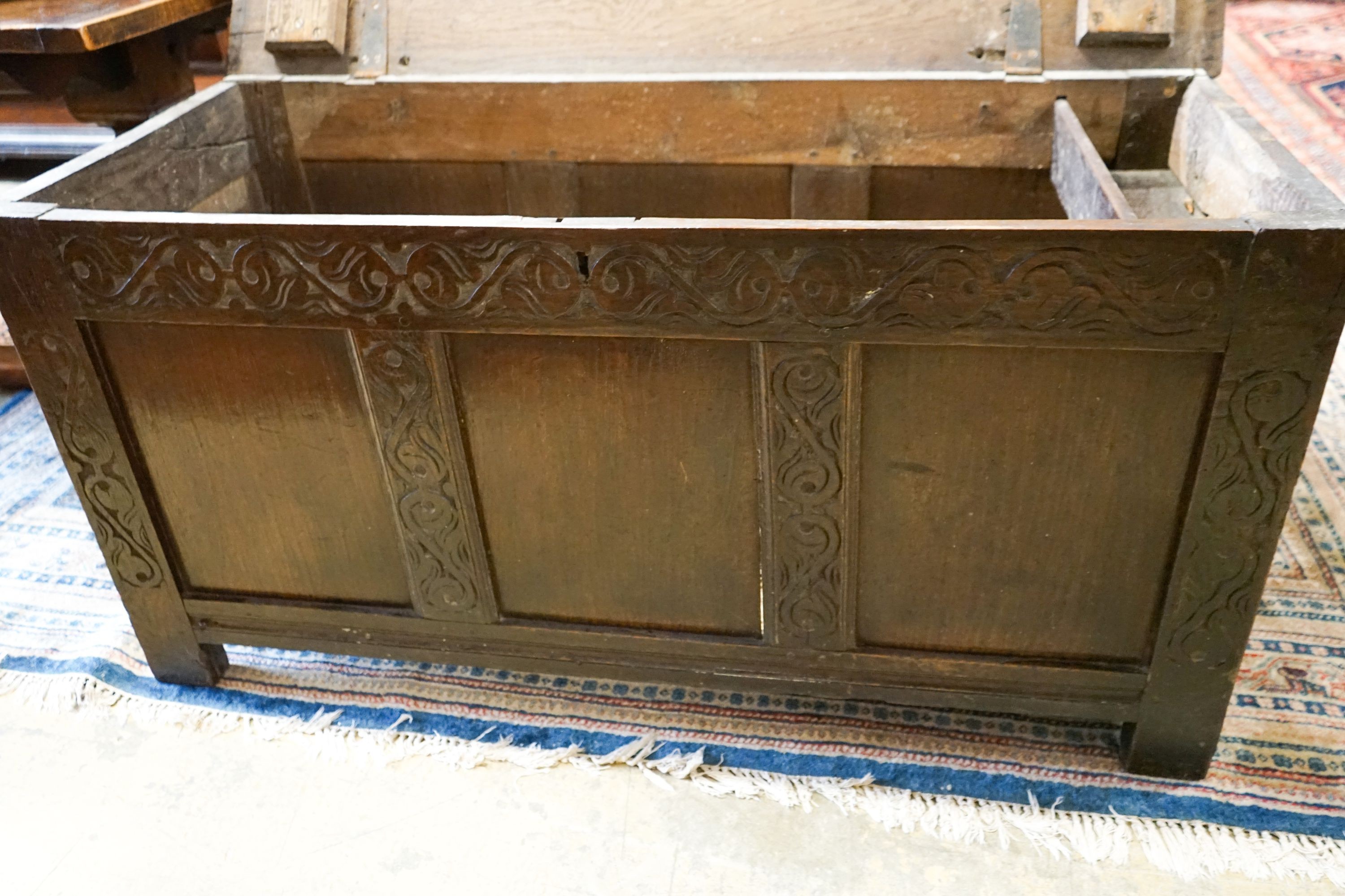 A late 17th / early 18th century carved and panelled oak coffer, length 136cm, depth 58cm, height 66cm